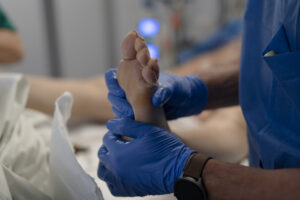 Examen du pied, mains gantées